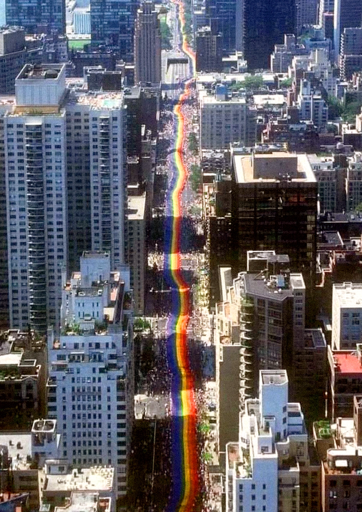 Gay activists carry a mile-long rainbow banner through New York City to mark the 25th anniversary of the Stonewall riots. June 26, 1994.