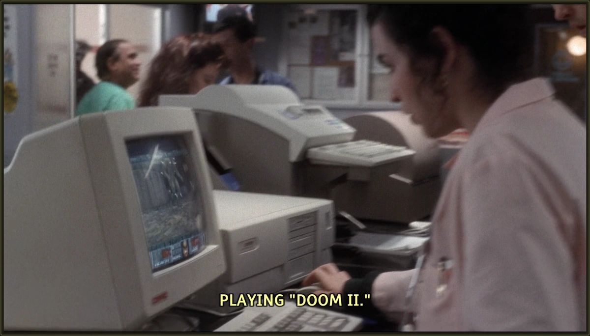 The beautiful nurse Carol Hathaway plays the video game DOOM II on the PC in the reception area of the hospital.